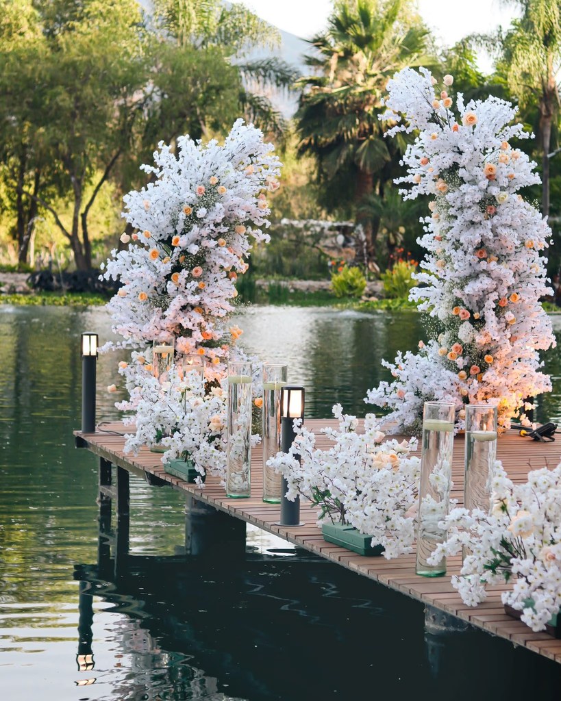 Floral ceremony arch over the lake